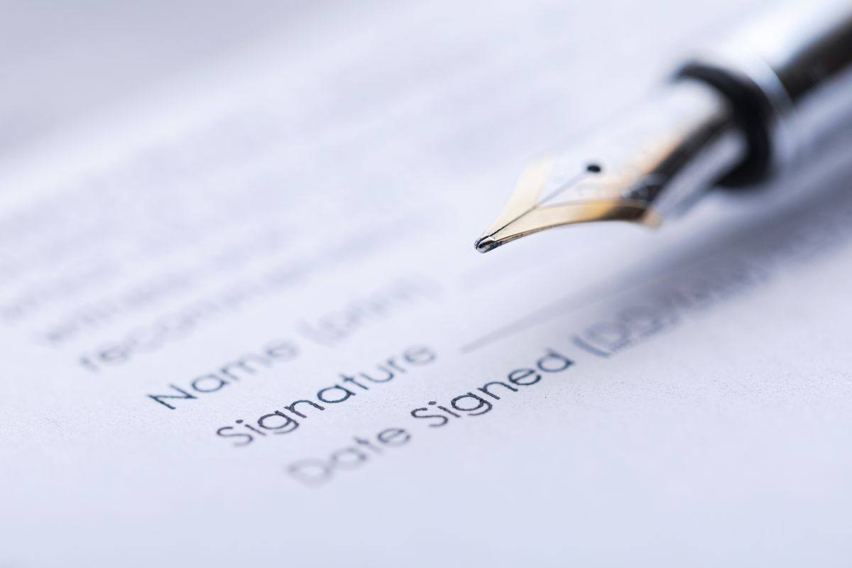 Signing the business contract. Fountain pen and document.