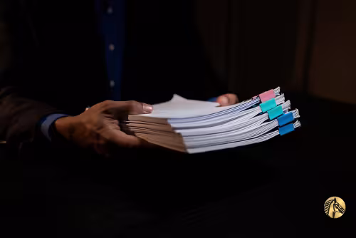 Hands holding a stack of legal financial documents from reliable proof of funds providers.