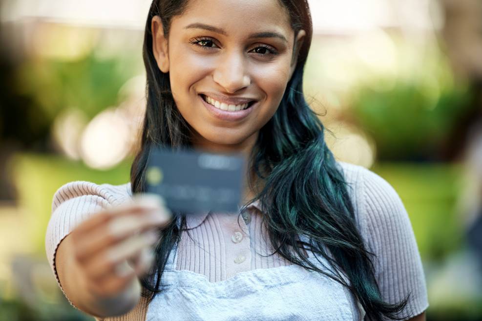 A professional getting her card after opening an offshore bank account online