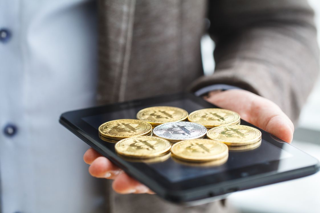 Business man pressing button bitcoin on tablet