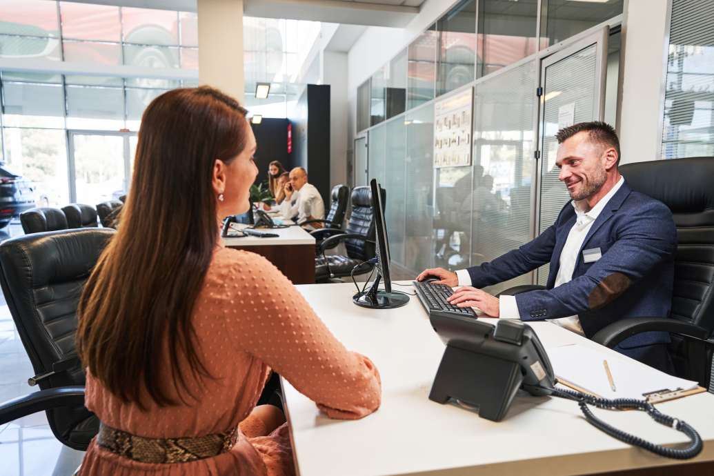 Friendly manager spending time with female customer on her inquiries for opening an offshore account