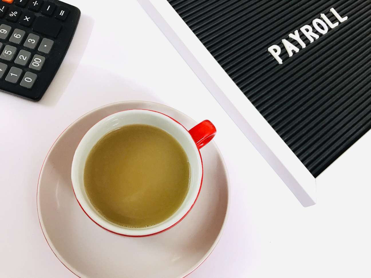 Payroll and hot coffee flat lay