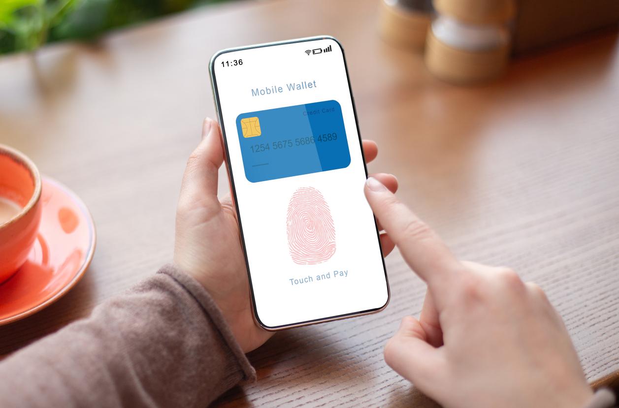 Person Holding Phone Showing Mobile Wallet App With Fingerprint Icon - one of the ways to prevent digital wallet fraud