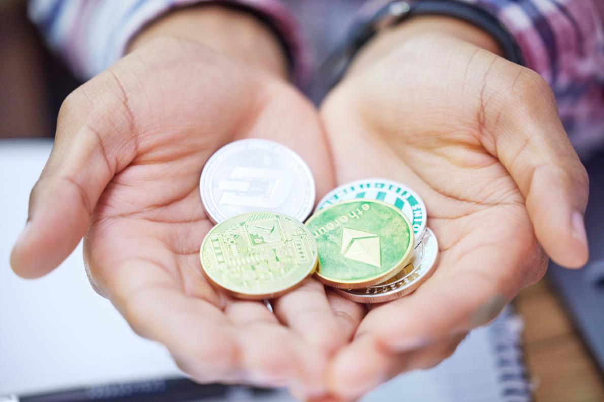 Shot of an unrecognisable man holding bitcoins