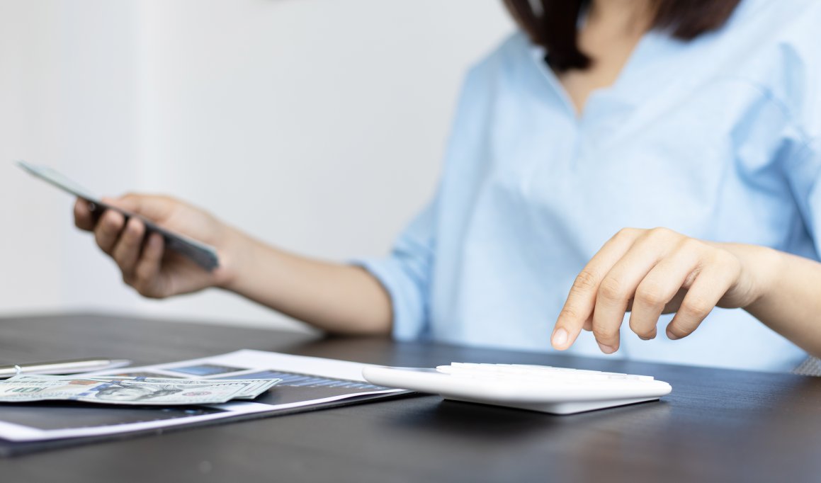 Woman in front of cash and calculator