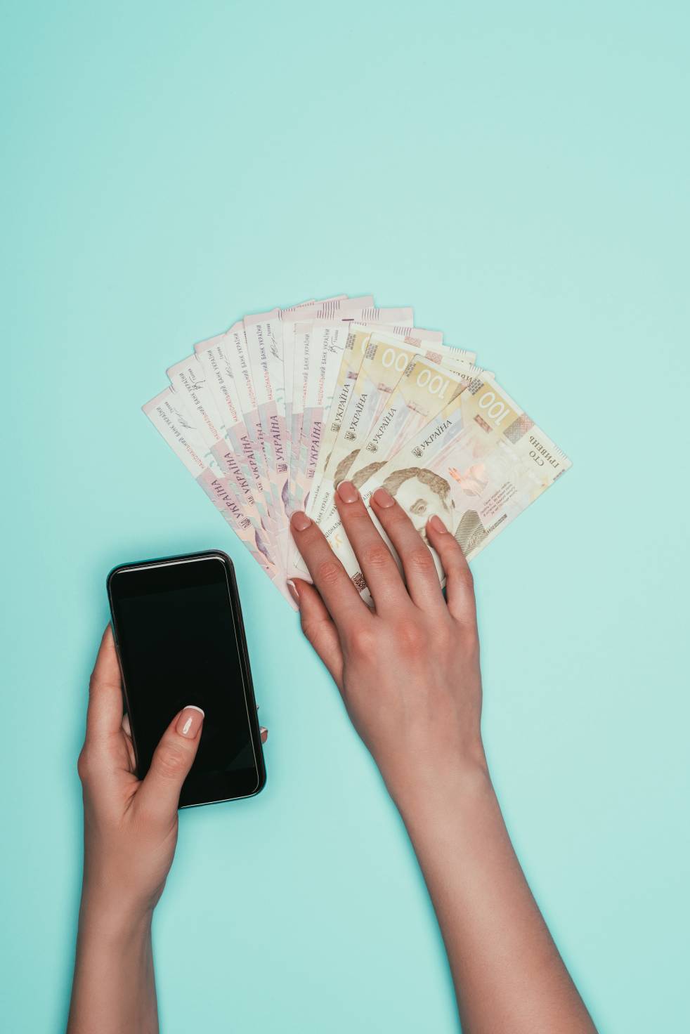 Woman with cash and smartphone