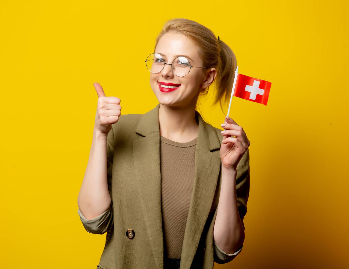 Young woman holding a flag of Switzerland