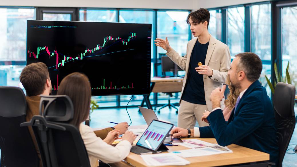 Young worker leading business meeting about deflationary cryptocurrencies in an office